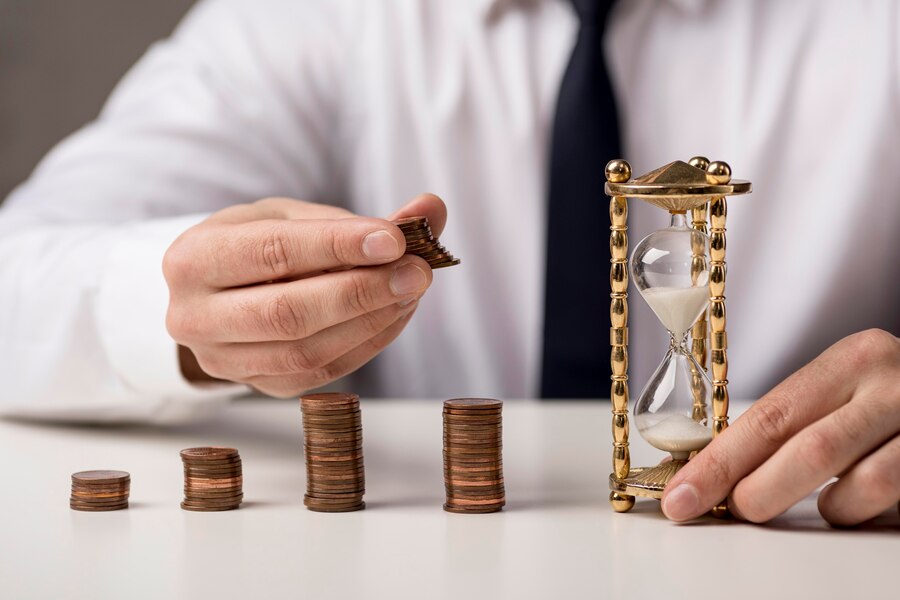 front-view-businessman-with-coins-hourglass_23-2148569070