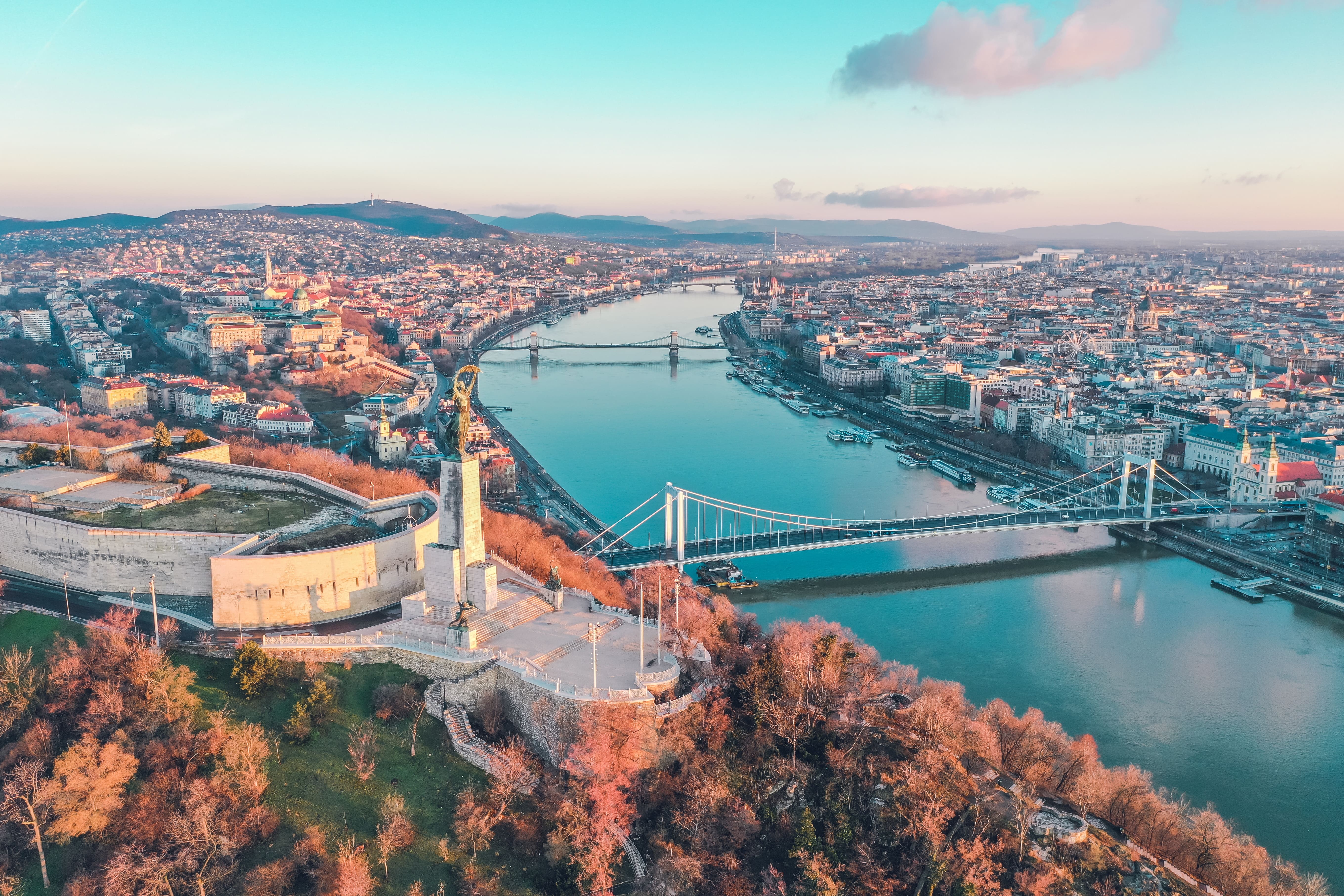 Aerial view of Budapest with the Danube River and the Liberty Bridge during sunset, showcasing Hungary EOR.